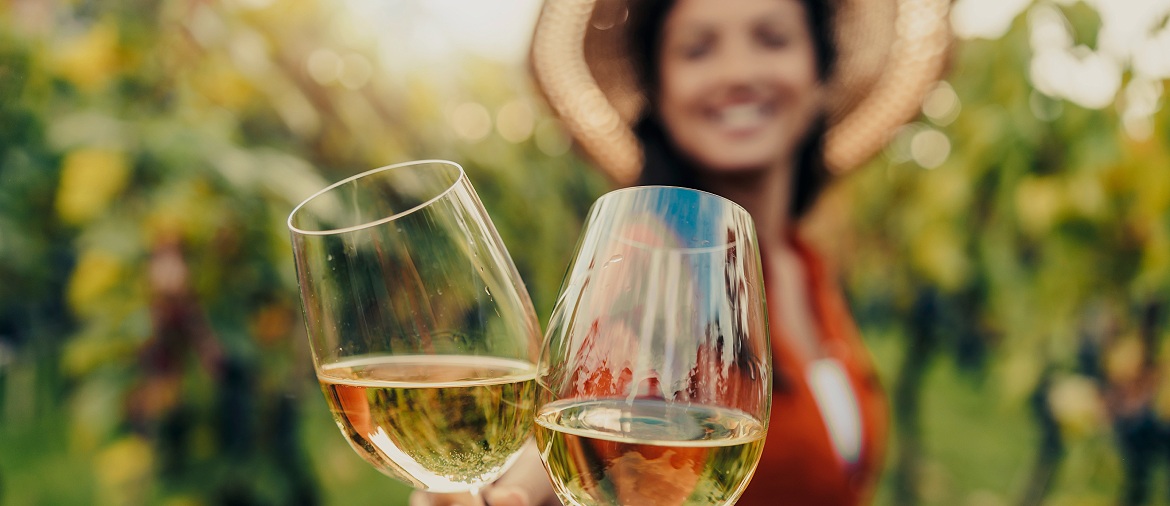 toasting in a vineayrd, woman in background